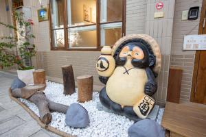 a statue of a penguin sitting in front of a building at Meet Xiashu in Jincheng