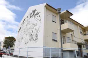 a building with a mural on the side of it at Nia Azorean Apartments in Horta