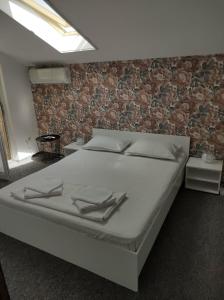 En eller flere senge i et værelse på Casa Jolie