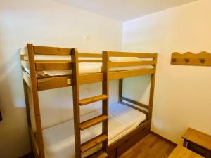 a room with three bunk beds in a room at Studio Montgenèvre, 1 pièce, 4 personnes - FR-1-445-142 in Montgenèvre