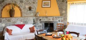 a living room with a couch and a fireplace at Villa Jewels ,casa vacanza in Gaggi