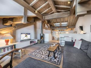 a living room with a couch and a table at Chalet Courchevel, 7 pièces, 13 personnes - FR-1-568-1 in Courchevel