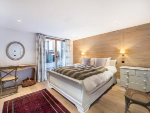 a bedroom with a large bed and a window at Chalet Courchevel, 7 pièces, 13 personnes - FR-1-568-1 in Courchevel