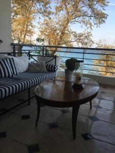 a coffee table with a candle on a balcony at Platamon sea view house in Platamonas