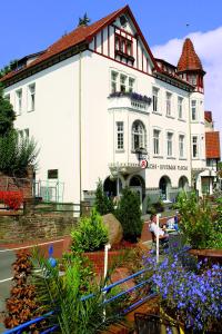 a large white building with flowers in front of it at Remedium Appartements in Vlotho