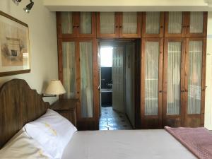 a bedroom with a bed and a door to a bathroom at Platamon sea view house in Platamonas