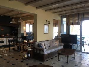 a living room with a couch and a table and a kitchen at Platamon sea view house in Platamonas