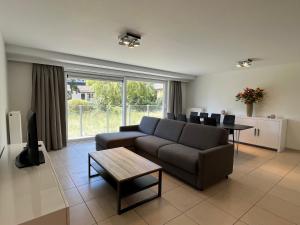a living room with a couch and a table at Botticelli in Koksijde