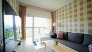 a living room with a couch and a table at Apartamenty EverySky - Kilińskiego 2 in Świeradów-Zdrój