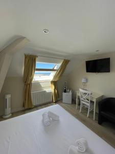 a living room with a large window and a couch at Les Embruns in Trouville-sur-Mer