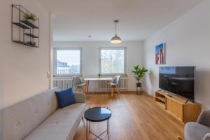 TV a/nebo společenská místnost v ubytování Glück Auf Appartements Lösorter Straße Duisburg