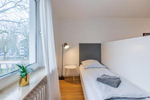 Postel nebo postele na pokoji v ubytování Glück Auf Appartements Lösorter Straße Duisburg