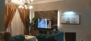 a living room with a couch and a tv at Cmk APARTMEN KOTA SRI MUTIARA# Free Netflix in Kota Bharu