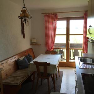 a kitchen with a table and a couch and a table at Schneiderhof in Steinbach