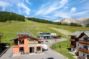 a small town in the mountains with a building at Chalet Letizia Apartments Trilo in Livigno