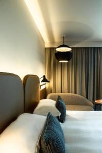 a hotel room with two beds and a lamp at Crowne Plaza - Nice - Grand Arenas, an IHG Hotel in Nice