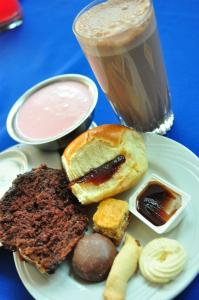 a plate of food with a drink and some pastries at Pousada das Águas in Serra Negra