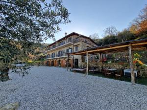 a large building on a gravel road next to a building at Dimora dei Cardinali in Agropoli