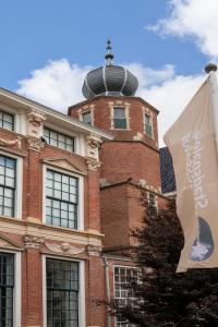 a building with a clock tower on top of it at Sterlogies City Apartment Monsieur Philippe in Leeuwarden +34 photos