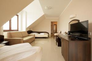 a large living room with a television and a couch at Holiday House Europa in Rewal