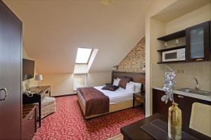 Postel nebo postele na pokoji v ubytování Hotel Aurum