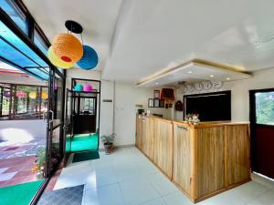 a living room with a television and a lobby at Hotel Sakura Durbar in Nagarkot