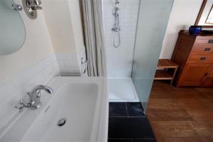 a bathroom with a white sink and a shower at The Forge in Rousdon +11 photos