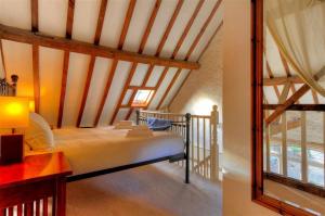 a bedroom with a large bed in a attic at The Forge in Rousdon