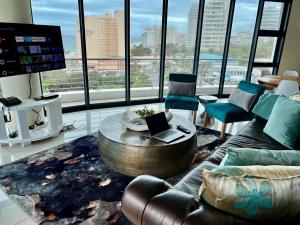 a living room with a couch and a coffee table at The Pearls of Umhlanga - Ocean view Apartments in Durban