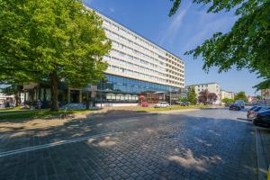 pusta ulica z dużym budynkiem w mieście w obiekcie Hotel New Skanpol w Kołobrzegu