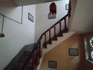 a staircase in a house with pictures on the wall at Divine view - Ac room for 2 pax - Swarna Bhavan in Puri