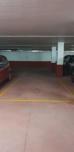 a parking garage with two cars parked in it at PIEDAD FERNANDEZ FERNANDEZ GESTION DE INMUEBLES SL. in Burela de Cabo