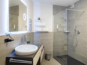 a bathroom with a sink and a glass shower at L'Opera Rooms & Suite in La Spezia +64 photos