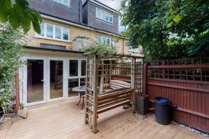 a wooden deck with a gazebo on a house at Spacious 4 bedroom home with garden in London in London
