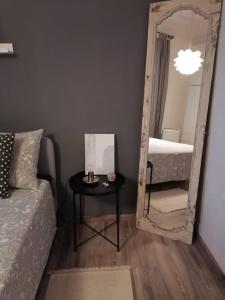 a room with a mirror and a table and a bed at AUXIMUM Appartamenti in Osimo