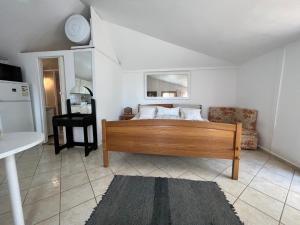 a bedroom with a bed and a chair in a room at Erdei házak in Csopak