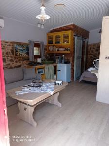 a living room with a table and a couch at Περιβόλι του Οδυσσέα in Volissos