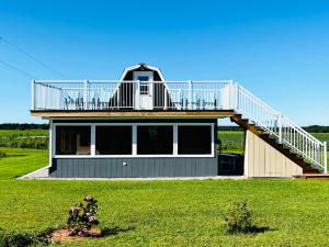 a house with a deck on top of it at Serendib by St Peters Bay in Saint Peters