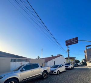 a row of cars parked in a parking lot at Suíte Brisa Mar Villa brisa icaraizinho in Amontada
