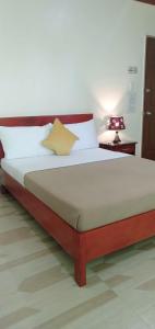 - un lit dans une chambre avec une lampe sur une table dans l'établissement Drew Hostel, à Tagbilaran