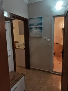 a room with a bathroom with a shower and a painting of a boat at Apartment See Breeze in Sunny Beach