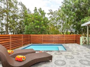 a swimming pool in a backyard with a wooden fence at Bains View Olive and Guest Farm in Wellington