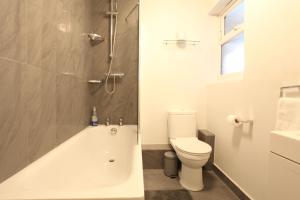a bathroom with a tub and a toilet and a shower at Lovely two bedroom apartment in London Old Street in London