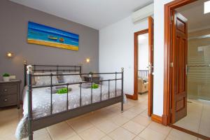 a bedroom with a bunk bed and a bathroom at Atlantis in Puerto Calero