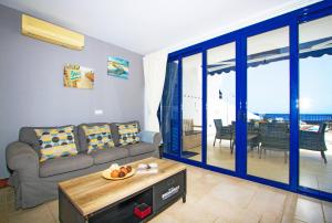 a living room with a couch and a table at Atlantis in Puerto Calero