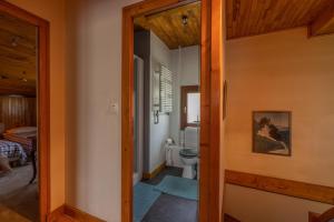 a hallway leading to a bathroom with a toilet at Chalet Le Margouillat in Les Houches +22 photos