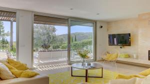 a living room with a couch and a table at Villa Vista in Crestatx