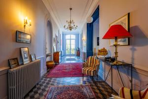 a hallway with a red lamp and a red rug at La Passerelle du Canal in Sallèles-dʼAude