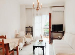 a living room with a couch and a table at Intimate Olympus House in Litochoro +39 photos