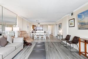 a living room with a couch and a dining room at 2-Bedroom Carolina Dunes Condo with Private Balcony and Ocean Views in Myrtle Beach